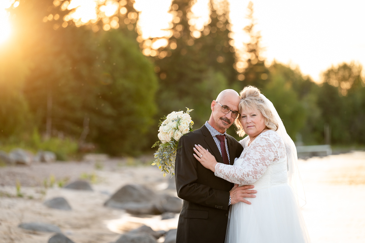 beach elopement, sunset session, sunset wedding, bride and groom sunset, bride and groom, wedding photographer, beach session, beach wedding, walking in the sand, sunset elopement, elopement photographer cold lake