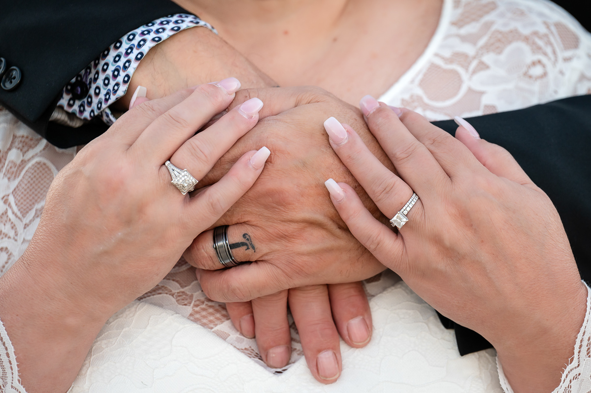 ring shot, bride and groom hugging, beach elopement, sunset session, sunset wedding, bride and groom sunset, bride and groom, wedding photographer, beach session, beach wedding, walking in the sand, sunset elopement, elopement photographer cold lake