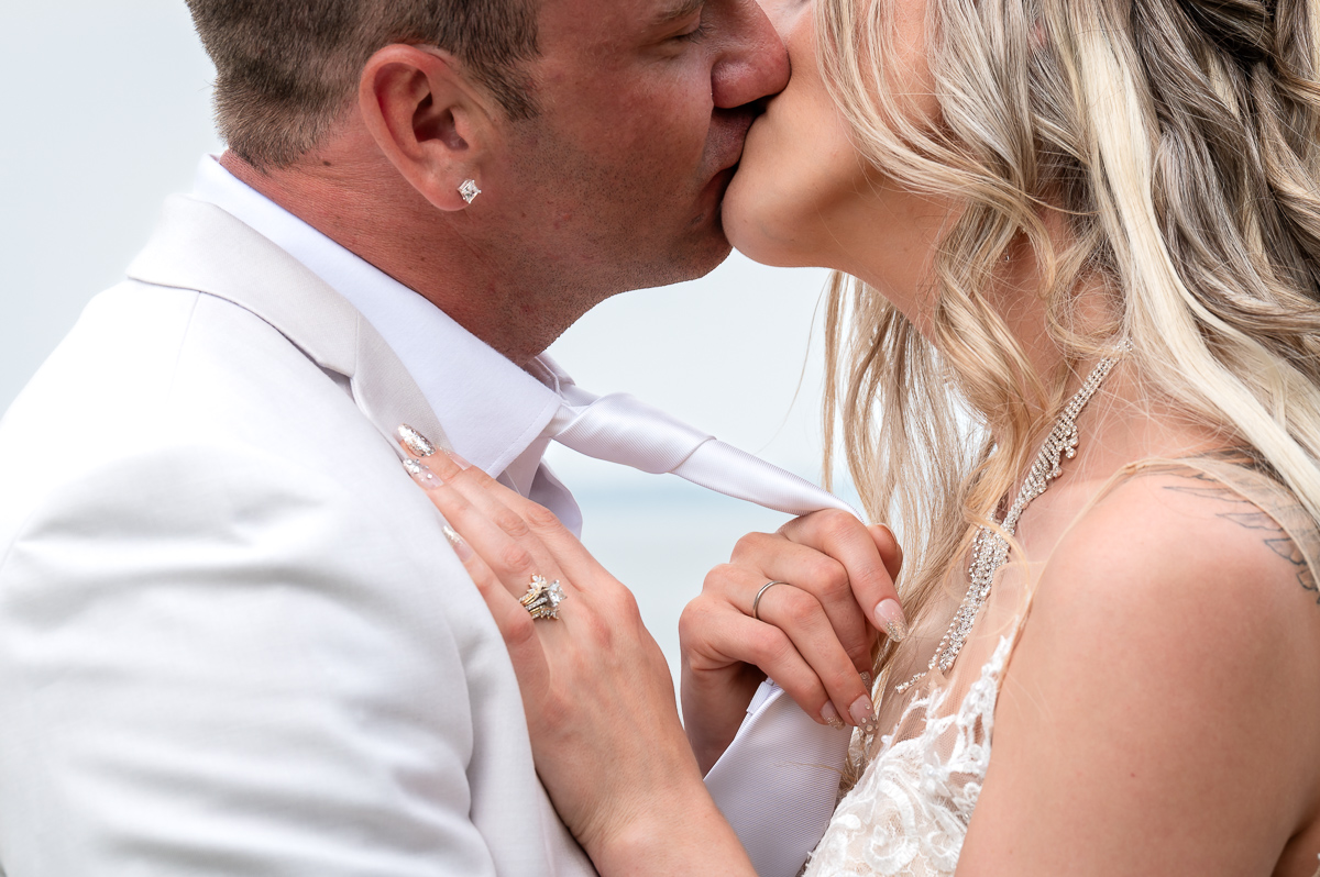 kiss shot, ring shot, pulling tie photo, beach wedding, unique wedding photographer near me, photographer near me,