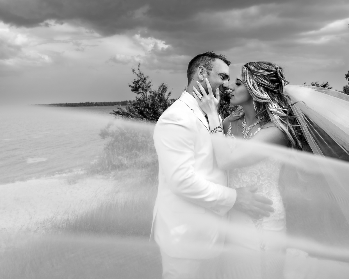 veil shot, wedding kiss, black white photo, beach wedding, franchere bay campground, praying, wide shot, wedding photography, unique wedding photographer, storming wedding, Bonnyville photographer, photographer near me,