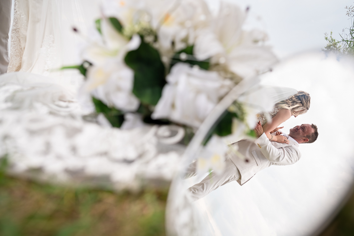 reflection shot, beach wedding, franchere bay campground, praying, wide shot, wedding photography, unique wedding photographer, dip kiss, Bonnyville photographer, photographer near me,
